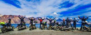 A group of riders on a thrilling motorcycle adventure tour through scenic landscapes in "Leh Ladakh Himalayas."